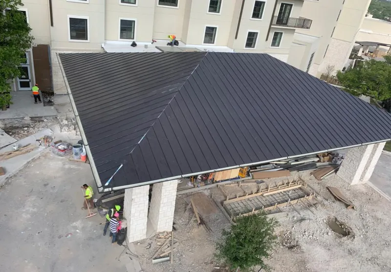 Metal roofing installation team working on a commercial building in Georgetown